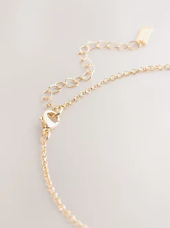 Goudkleurig - Ketting met hangertje van vereende ringen