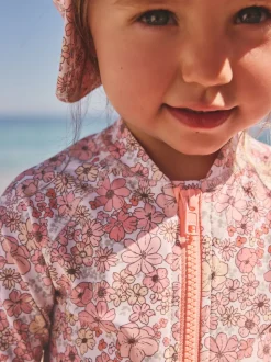 Koraalroze met fijne bloemenprint - Zonbeschermend badpak met lange pijpen (3 mnd-7 jr)