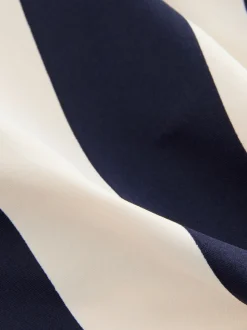 Marineblauw/crèmekleurig - Badpak met vormgevende zijrimpeling en buikcorrectie