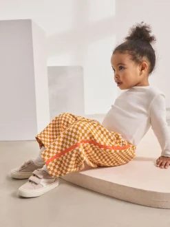 Oranje met dambordmotief - Broek met wijde kortere pijpen (3mnd -7jr)