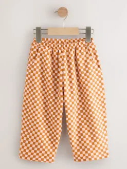 Oranje met dambordmotief - Broek met wijde kortere pijpen (3mnd -7jr)