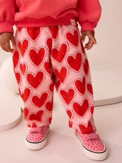 Rood met hartjesprint - Broek met structuur en wijde kortere pijpen (3mnd -7jr)