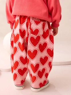 Rood met hartjesprint - Broek met structuur en wijde kortere pijpen (3mnd -7jr)