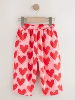 Rood met hartjesprint - Broek met structuur en wijde kortere pijpen (3mnd -7jr)