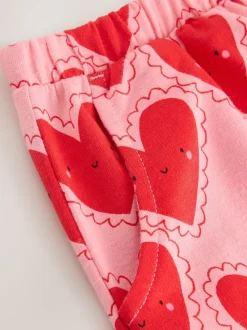 Rood met hartjesprint - Broek met structuur en wijde kortere pijpen (3mnd -7jr)