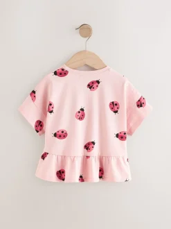 Roze lieveheersbeestje - T-shirt met peplum en korte mouwen (3mnd -7jr)