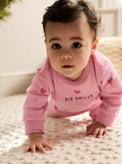 Roze met hartjesprint - Jersey babyromper (0mnd-3jr)