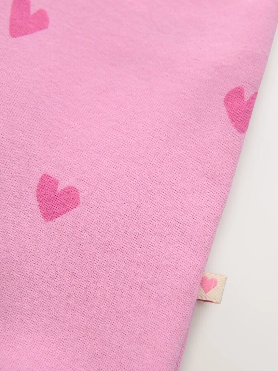 Roze met hartjesprint - Jersey babyromper (0mnd-3jr)