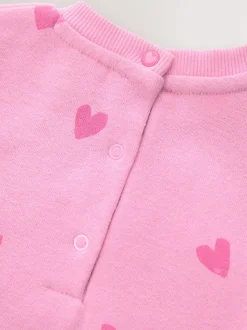 Roze met hartjesprint - Jersey babyromper (0mnd-3jr)
