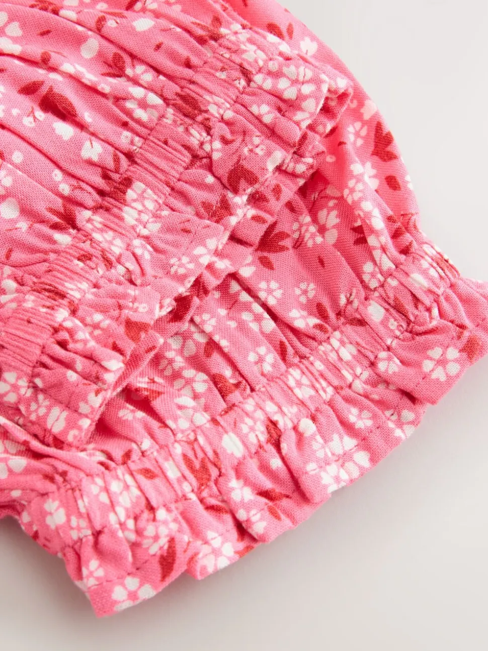 Roze met vrolijke print - Gesmokte blouse (3-16jr)
