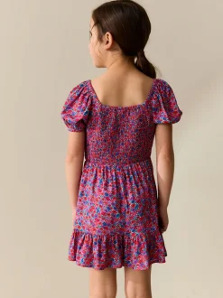 Roze met vrolijke print - Romper met smokwerk (3-16jr)