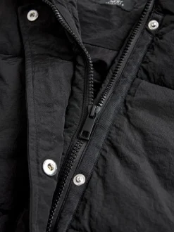 Zwart - Regenbestendige bodywarmer met capuchon en gebreide kraag
