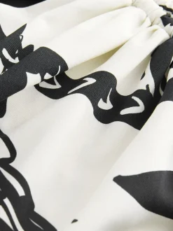 Zwart/Crème Palm - Badpak met vormgevende zijrimpeling en buikcorrectie