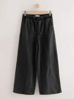 Zwarte wassing - Denim joggingbroek met plooitjes en wijde pijpen