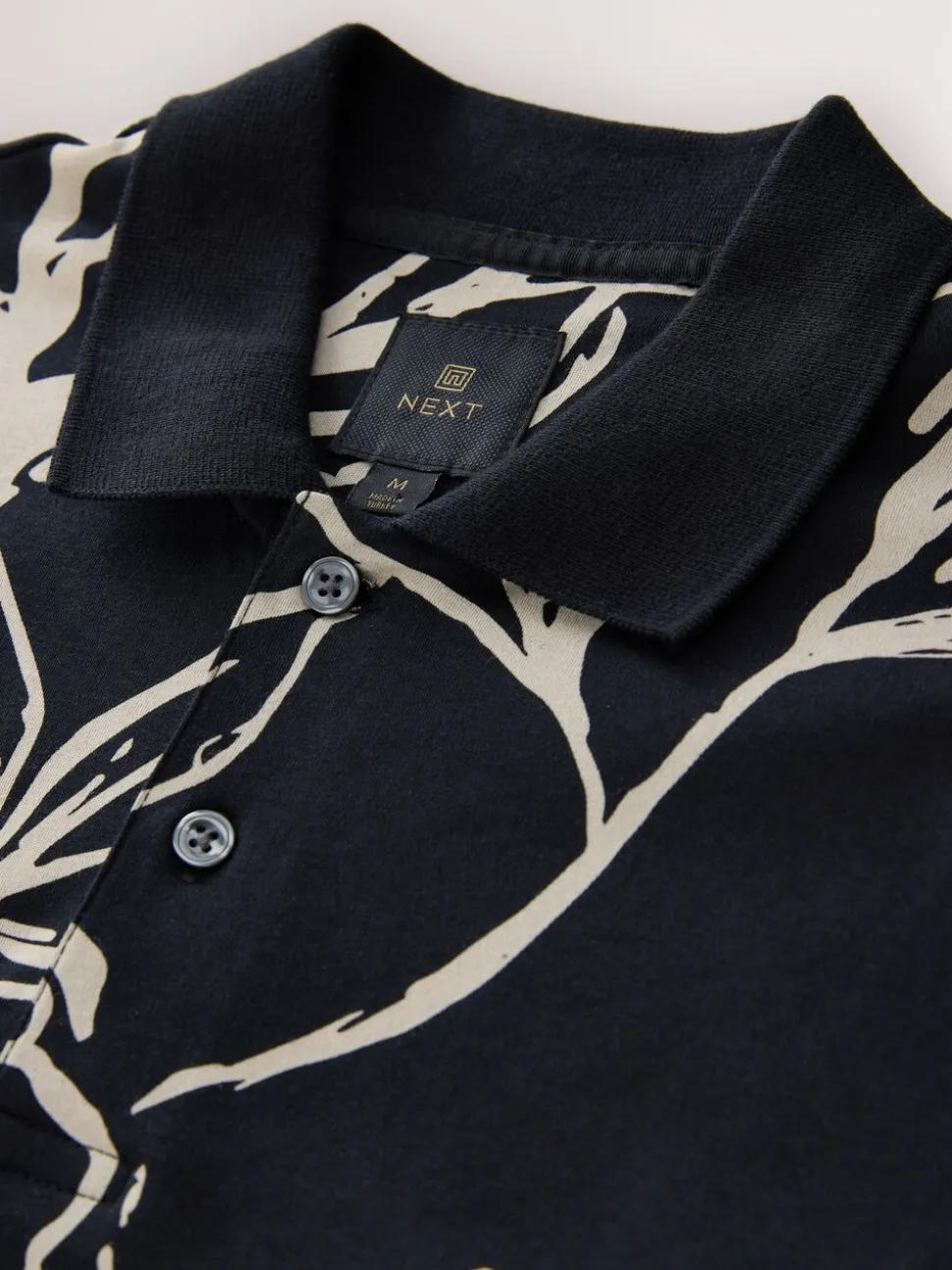 Zwartgoud met bloemenprint - Poloshirt met korte mouwen en print
